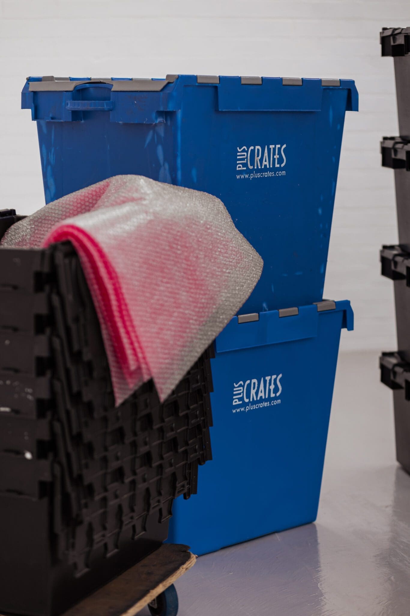 two blue plastic crates for hire